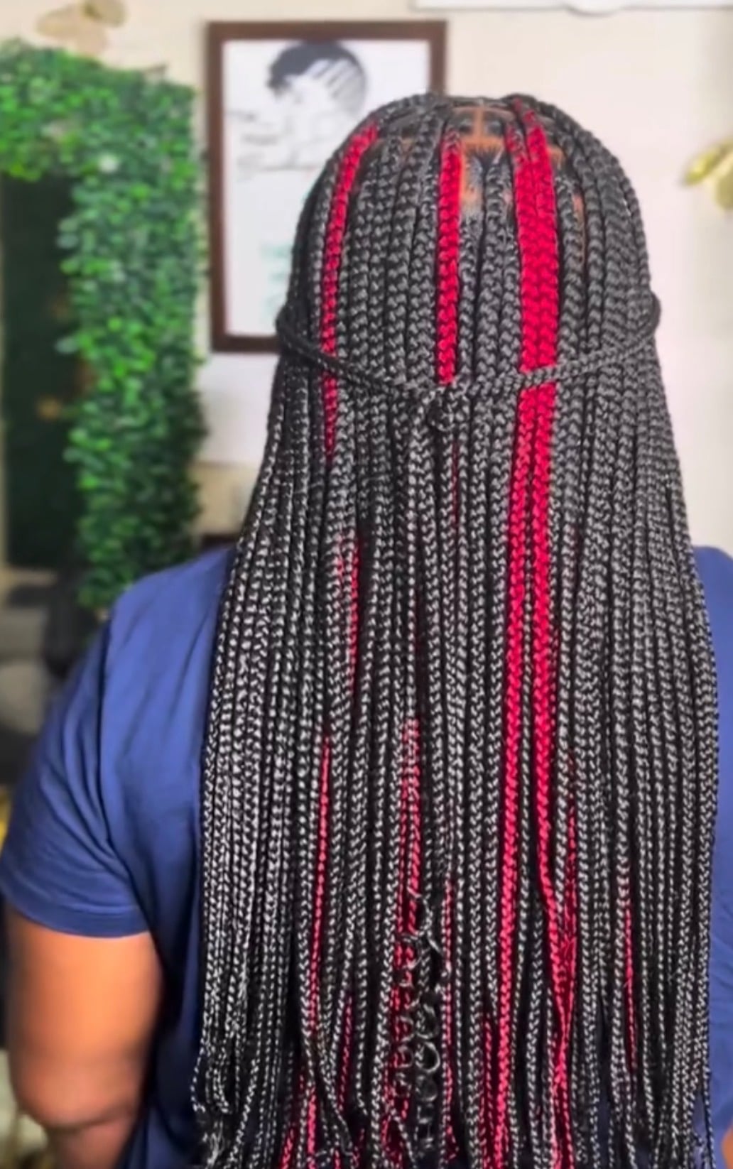 Box braids with red accents